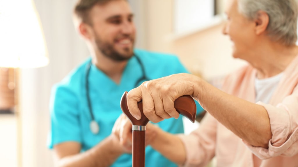 Medical Worker Taking Care of Elderly Woman in Geriatric Hospice